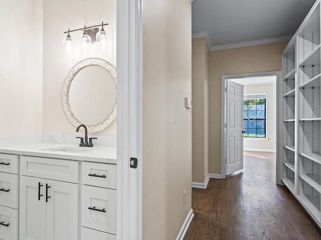 bathroom featuring vanity, hardwood / wood-style flooring, and crown molding