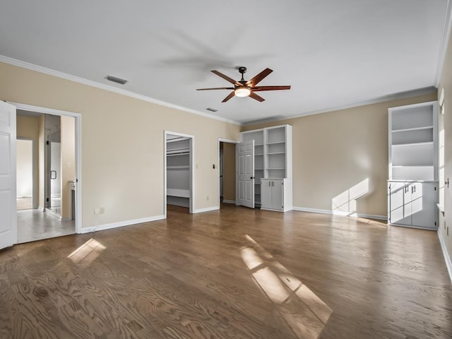 interior space featuring ceiling fan, dark hardwood / wood-style floors, and crown molding