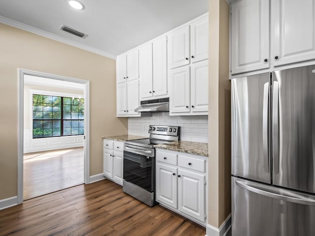 kitchen featuring white cabinetry, stainless steel appliances, and dark stone counters