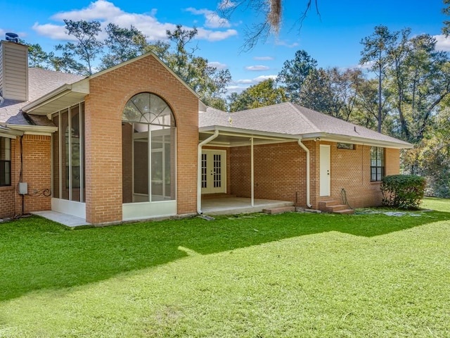 rear view of house with a patio area and a yard