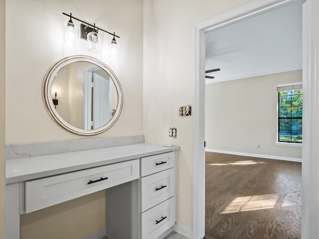 bathroom with hardwood / wood-style floors, ceiling fan, and vanity