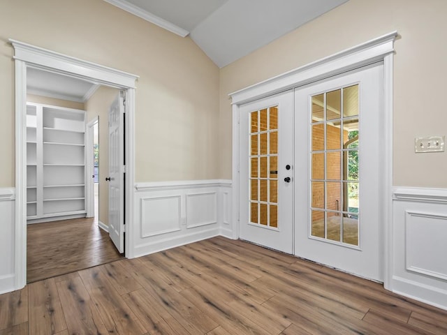 entryway with french doors, hardwood / wood-style flooring, ornamental molding, and vaulted ceiling