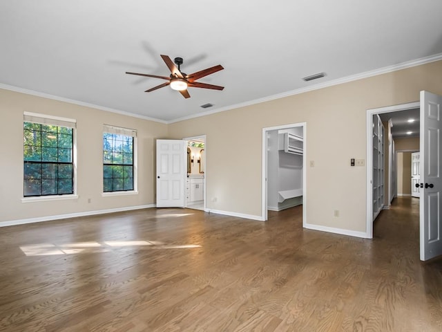 unfurnished living room with ceiling fan, dark hardwood / wood-style flooring, and ornamental molding