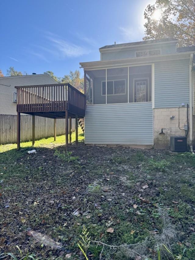 exterior space featuring a sunroom, a deck, and central AC