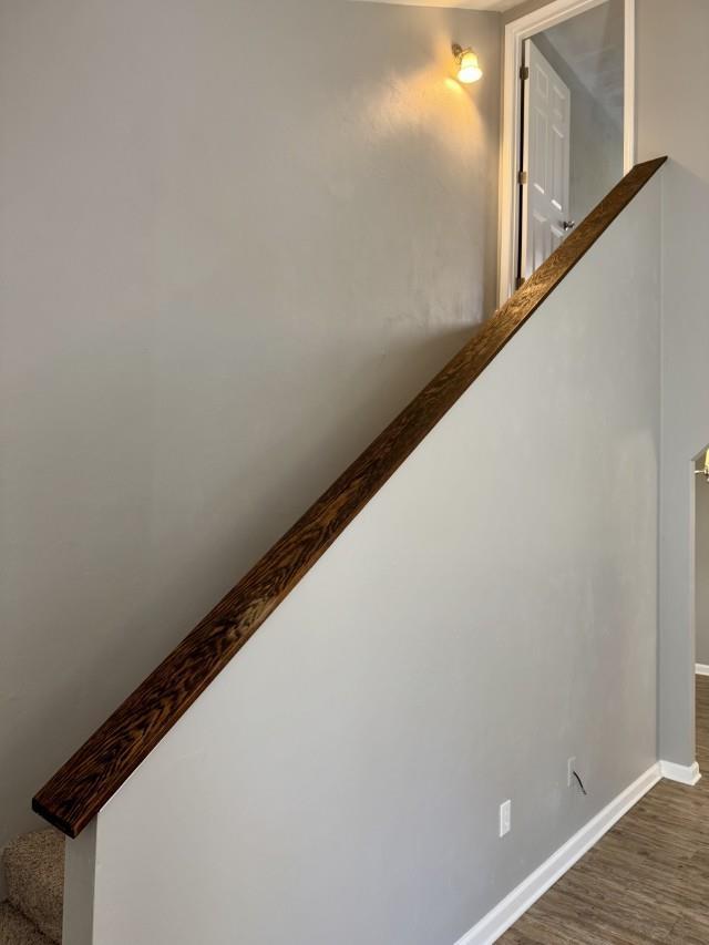 stairway with hardwood / wood-style floors