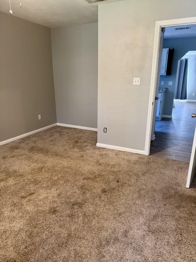 empty room with dark wood-type flooring