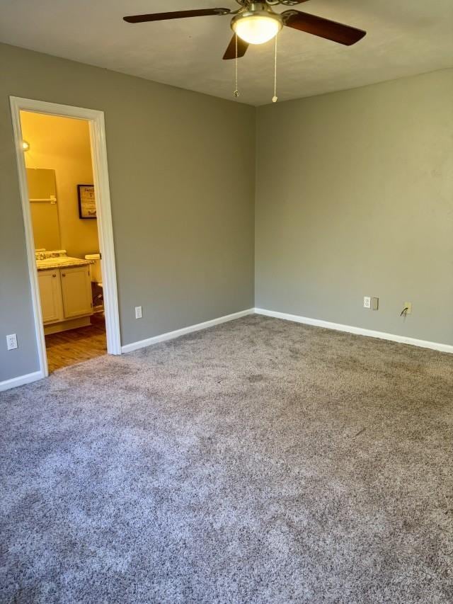 carpeted empty room with ceiling fan