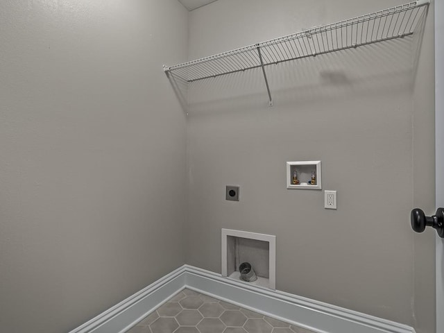 27 Spokan Trl, Crawfordville, FL 32327 - laundry area with electric dryer hookup, dark tile patterned floors, and hookup for a washing machine