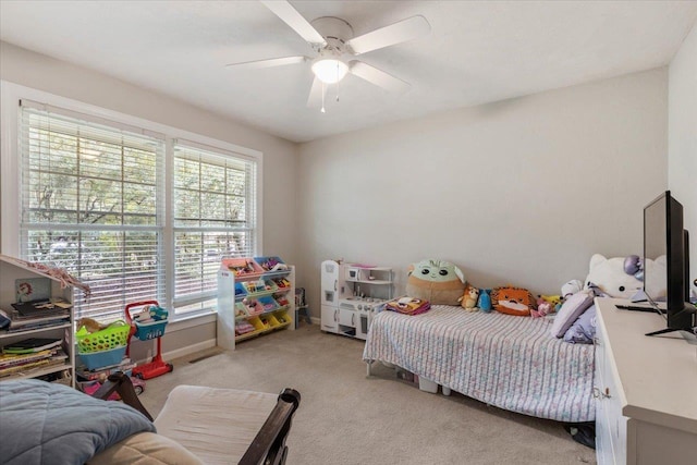 bedroom featuring ceiling fan and light carpet