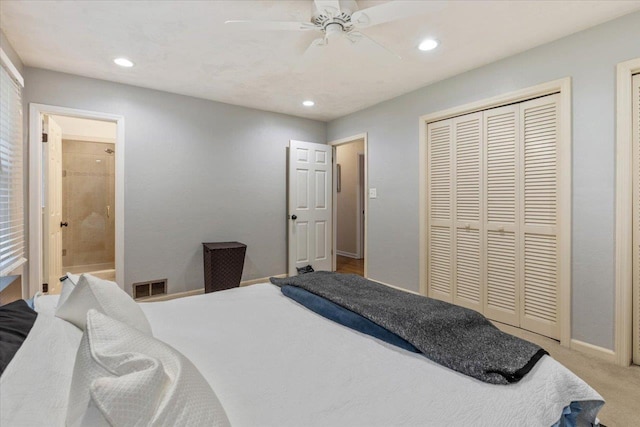 bedroom featuring a closet, ensuite bathroom, ceiling fan, and carpet