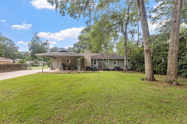 rear view of house with a yard