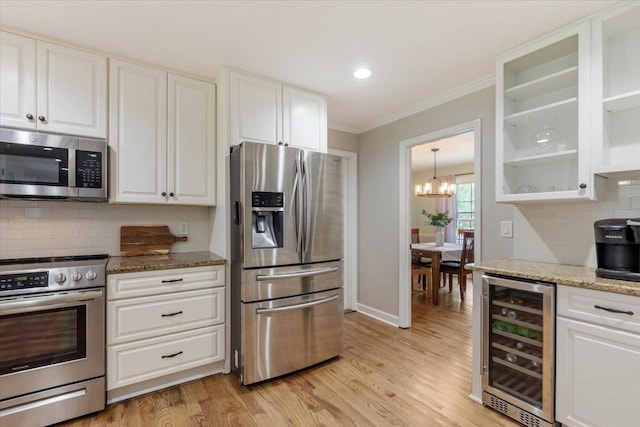 kitchen featuring wine cooler, white cabinetry, and stainless steel appliances