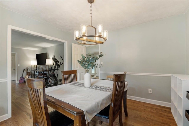 dining room featuring wood-type flooring and a chandelier