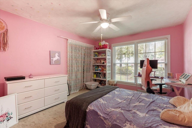 bedroom with light colored carpet and ceiling fan