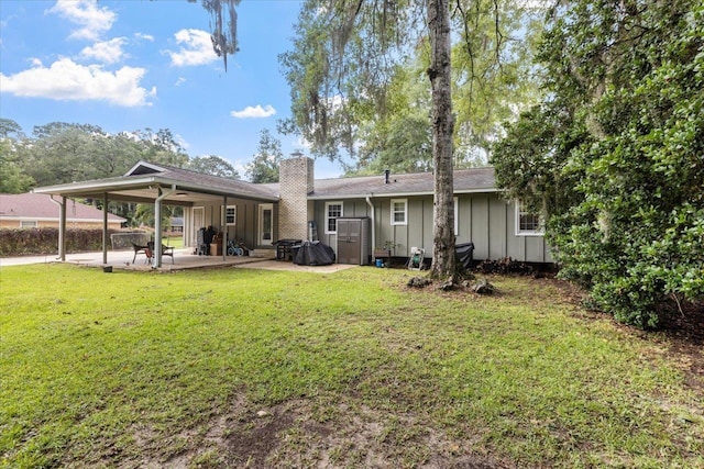 back of property featuring a yard and a patio area