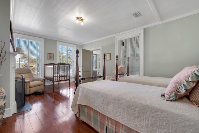 bedroom featuring crown molding and dark hardwood / wood-style flooring