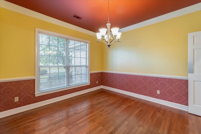 unfurnished room featuring wallpapered walls, visible vents, and wood finished floors