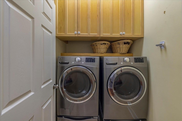 laundry area with washer and dryer and cabinet space