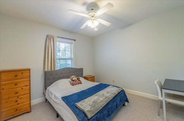 bedroom with light carpet, a ceiling fan, and baseboards