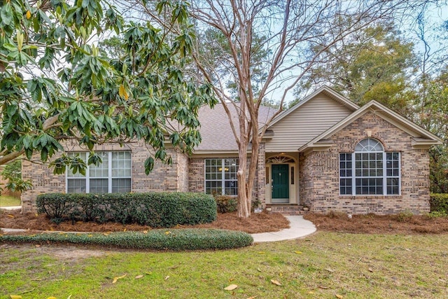 ranch-style house with brick siding and a front lawn