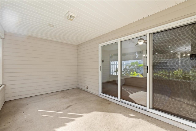 unfurnished sunroom with ceiling fan