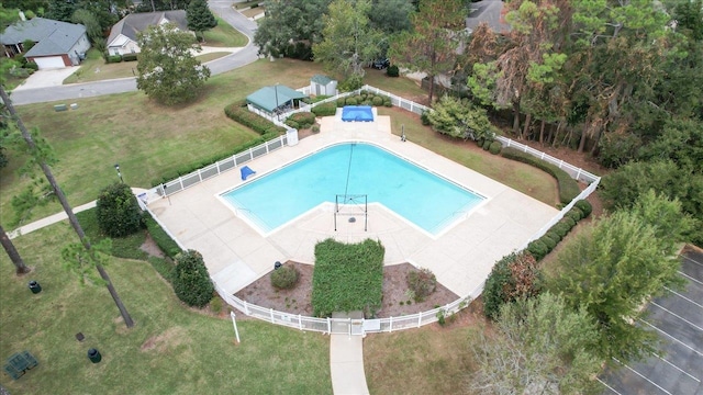 view of pool featuring a patio and a yard