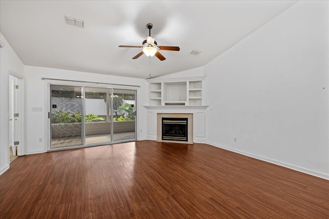 unfurnished living room with built in features, hardwood / wood-style floors, vaulted ceiling, and ceiling fan