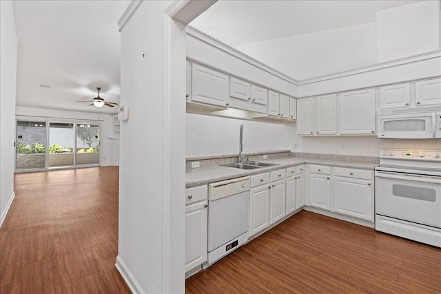 kitchen with white cabinetry, white appliances, sink, and hardwood / wood-style flooring