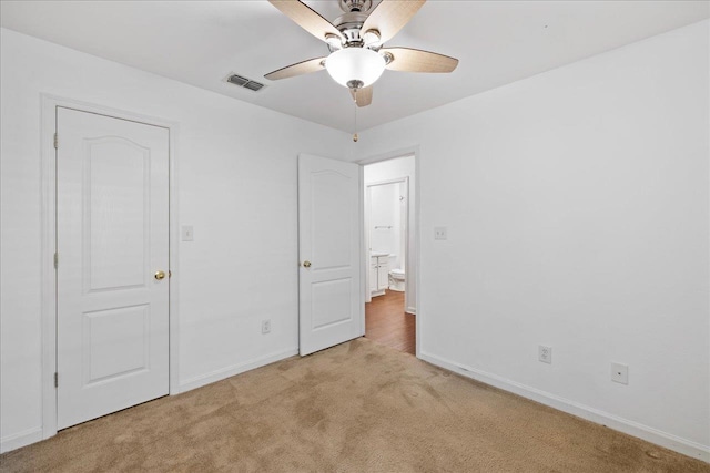 unfurnished bedroom with light carpet and ceiling fan