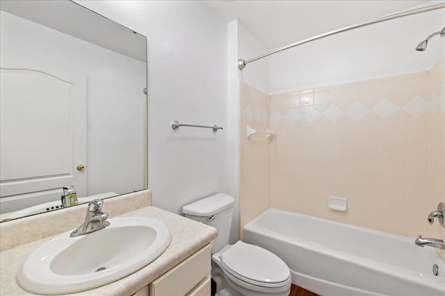 full bathroom with toilet, vanity, and tiled shower / bath