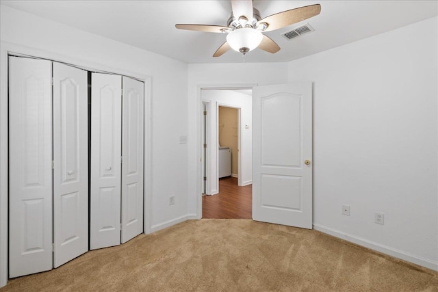 unfurnished bedroom featuring a closet, light carpet, and ceiling fan