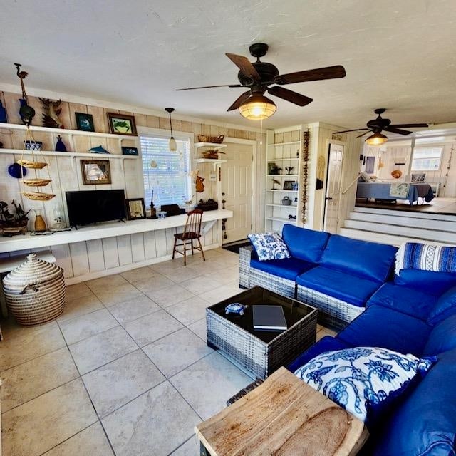 tiled living room with ceiling fan