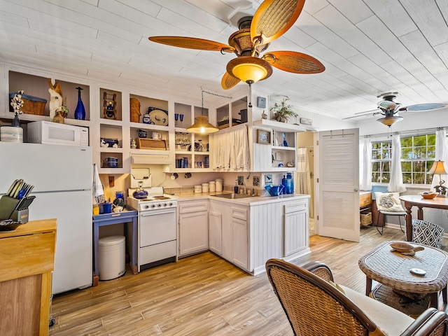 kitchen featuring white cabinetry, decorative light fixtures, white appliances, ceiling fan, and light hardwood / wood-style flooring