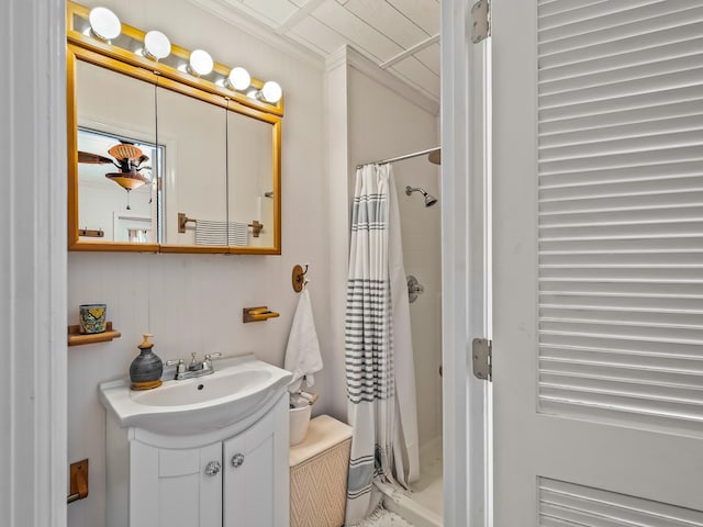 bathroom with crown molding, vanity, and a shower with shower curtain