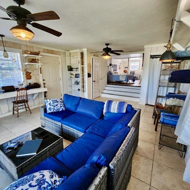 living room featuring tile patterned flooring and ceiling fan