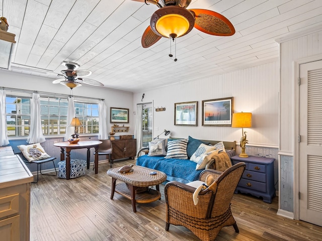 living room featuring wooden walls, hardwood / wood-style flooring, ceiling fan, and wood ceiling