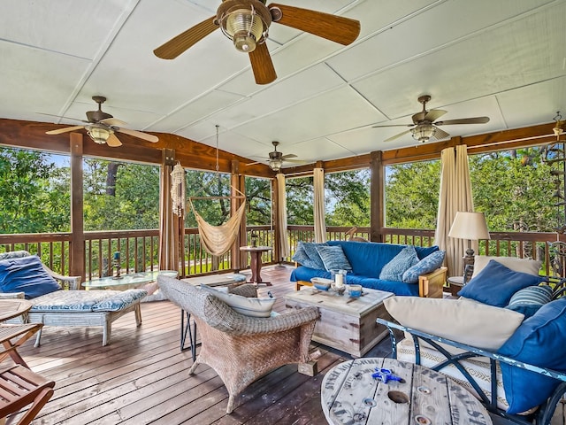 sunroom featuring ceiling fan and vaulted ceiling