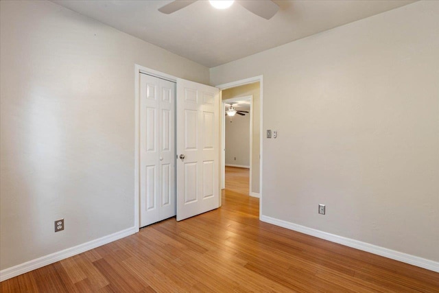 unfurnished bedroom with a closet, ceiling fan, and light hardwood / wood-style flooring