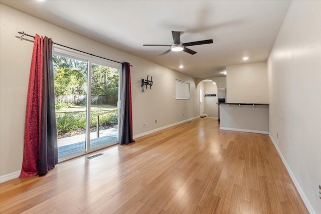 unfurnished living room with ceiling fan and light wood-type flooring