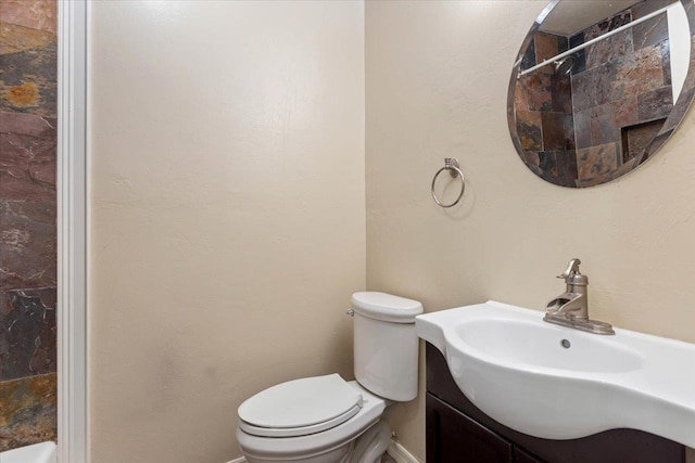 bathroom with vanity, toilet, and walk in shower