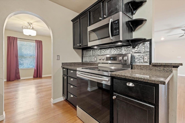 kitchen with tasteful backsplash, ceiling fan, light hardwood / wood-style flooring, and stainless steel appliances