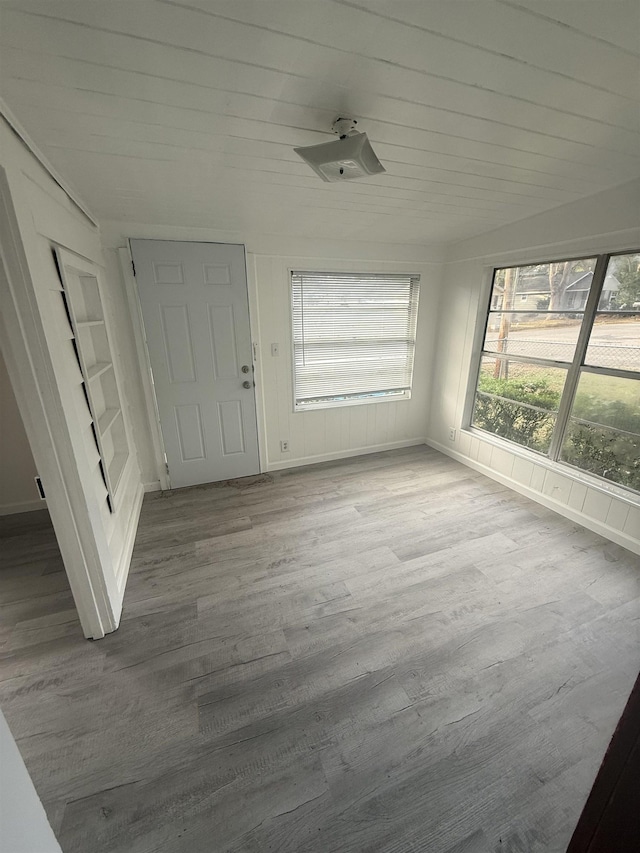 unfurnished sunroom with wood ceiling