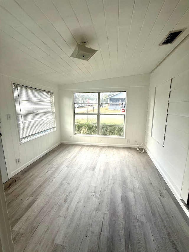 unfurnished sunroom with wooden ceiling