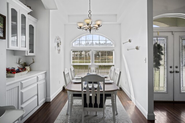 11488 NW Summers Rd, Bristol, FL 32321 - dining room with dark wood-type flooring, a chandelier, baseboards, and a tray ceiling
