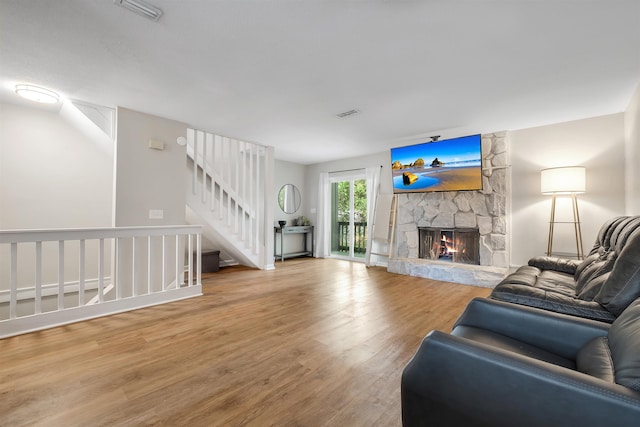 1200 Cross Creek Way Unit 4, Tallahassee, FL 32301 - living room with wood finished floors, a stone fireplace, and stairway