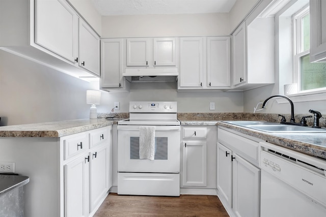 1200 Cross Creek Way Unit 4, Tallahassee, FL 32301 - kitchen with white appliances, under cabinet range hood, white cabinetry, dark wood-type flooring, and a peninsula