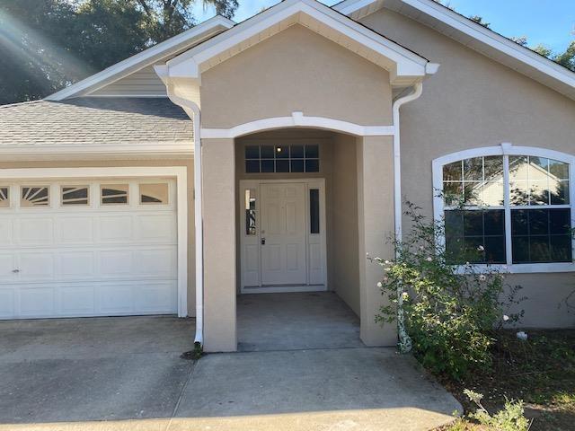 view of exterior entry featuring a garage