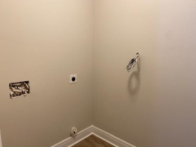 washroom featuring wood-type flooring and hookup for an electric dryer