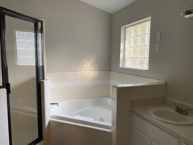 bathroom featuring plus walk in shower and vanity