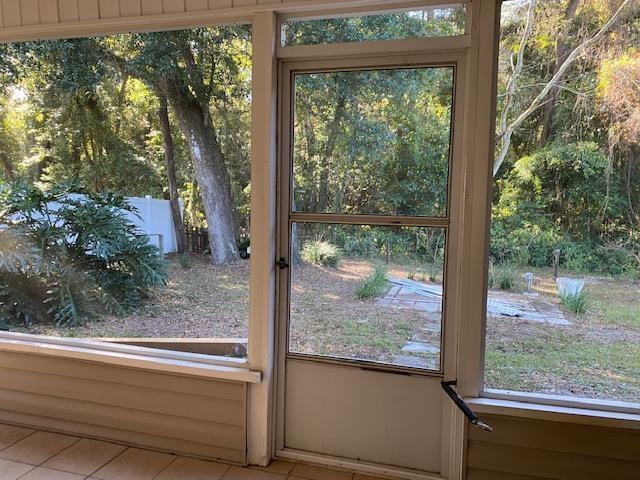 doorway to outside featuring light tile patterned flooring